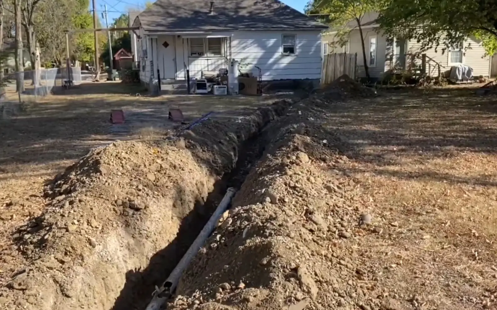 new PVC sewer line laid in an open trench