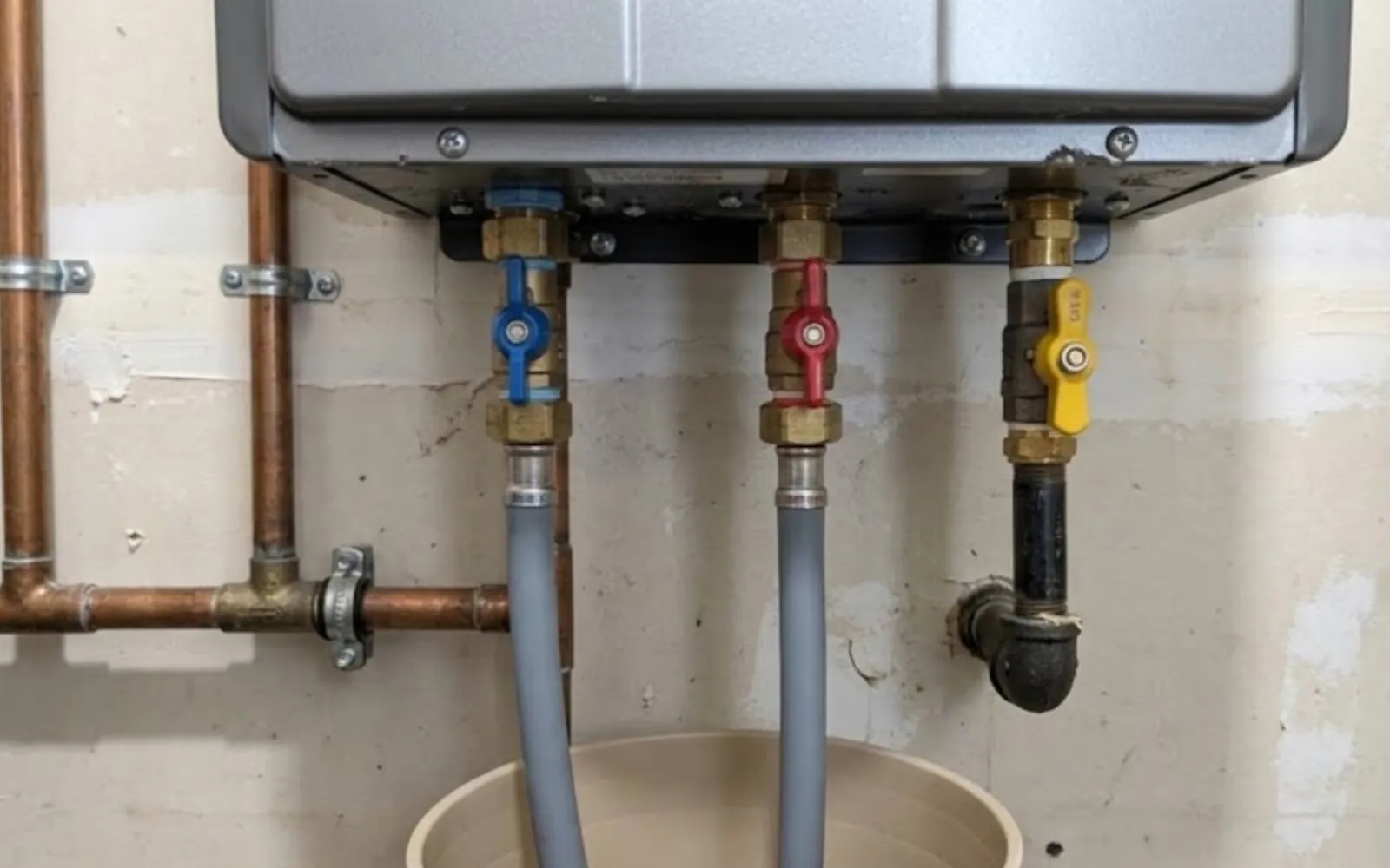 tankless water heater being descaled through its service valves