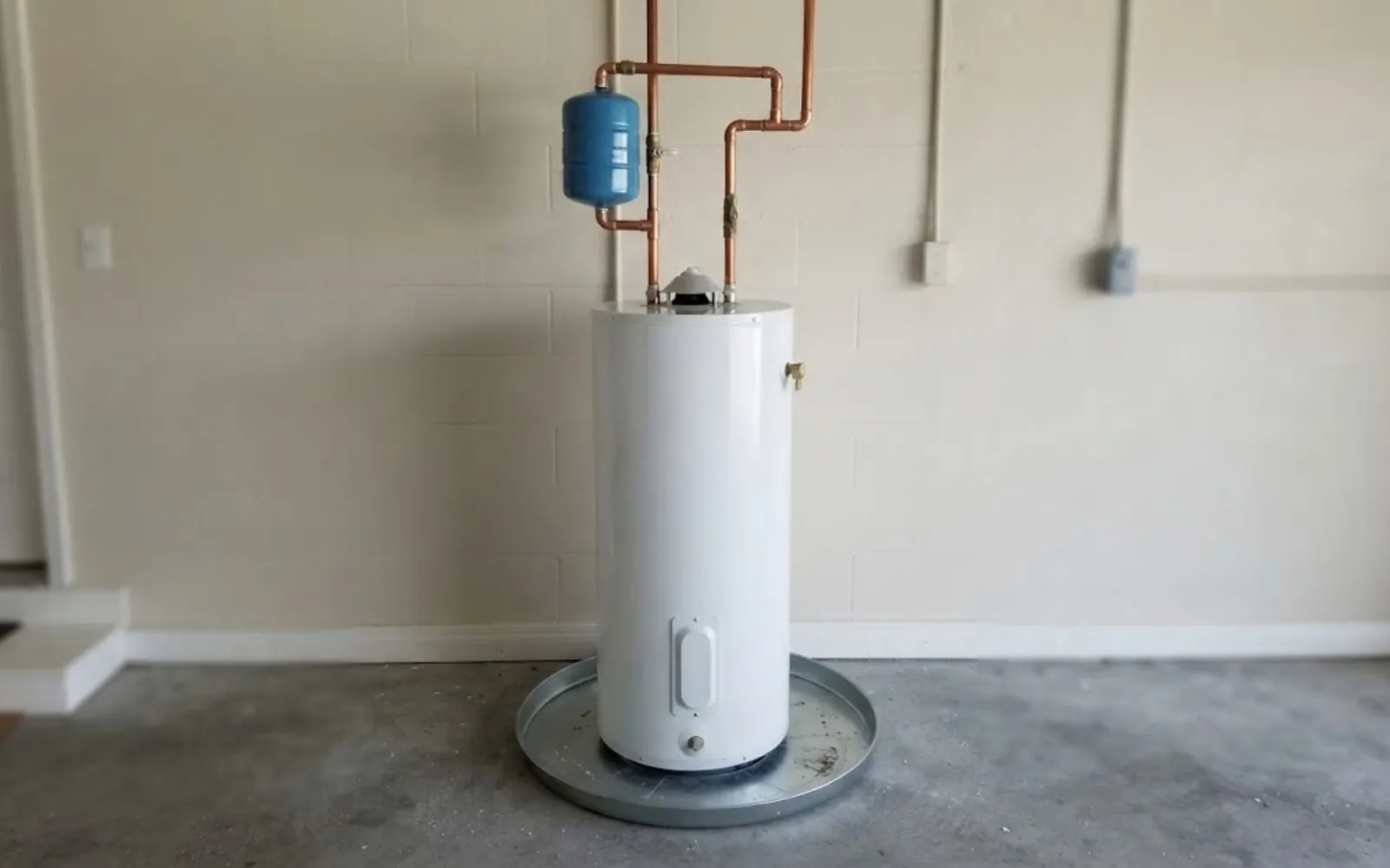 newly installed water heater with drain pan and expansion tank