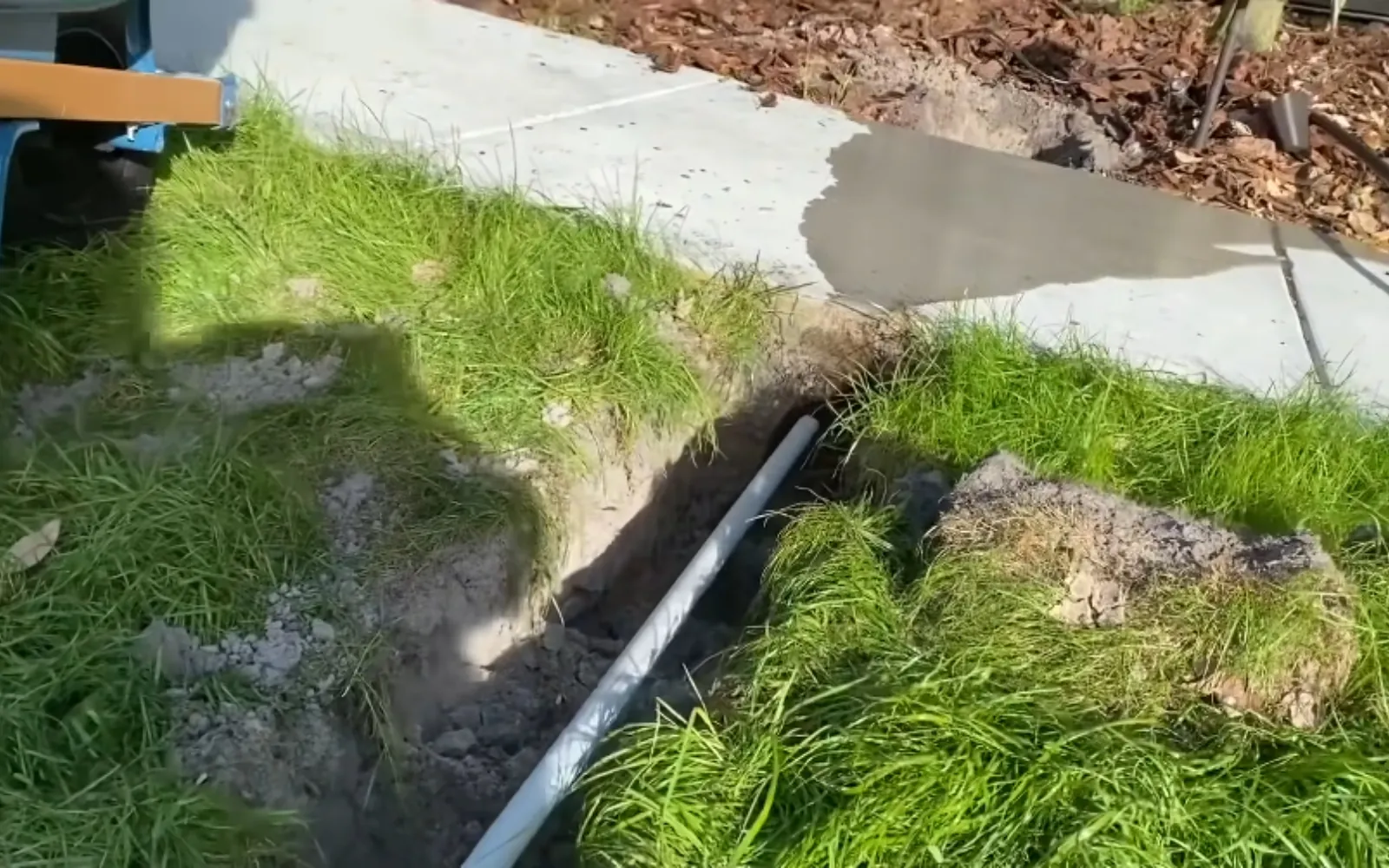 trench in a front yard exposing a buried water service line
