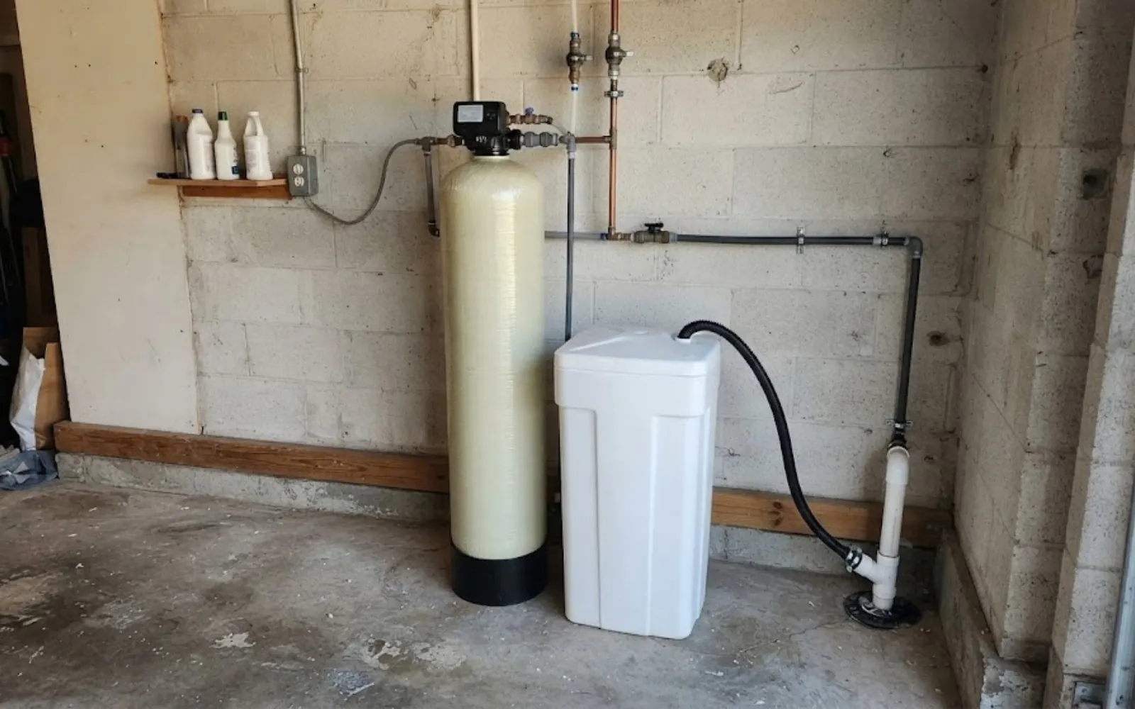 water softener and brine tank installed in a garage